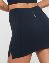 Black athletic skirt with a brand logo on a light gray background