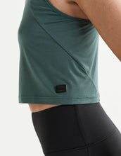 Green athletic top with a brand logo on a white background