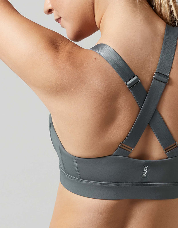 Gray sports bra worn by a person on a light gray background