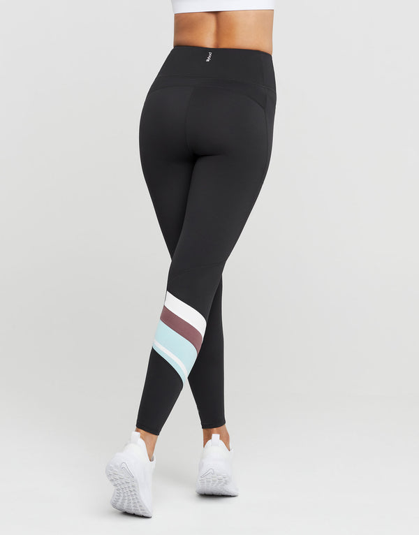 Black leggings with colorful stripes worn by a person on a white background