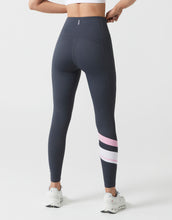 Dark gray leggings with pink and white accents worn by a person on a white background