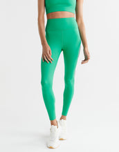 Green leggings worn by a person on a white background