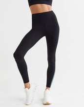 Person wearing black leggings with a white background