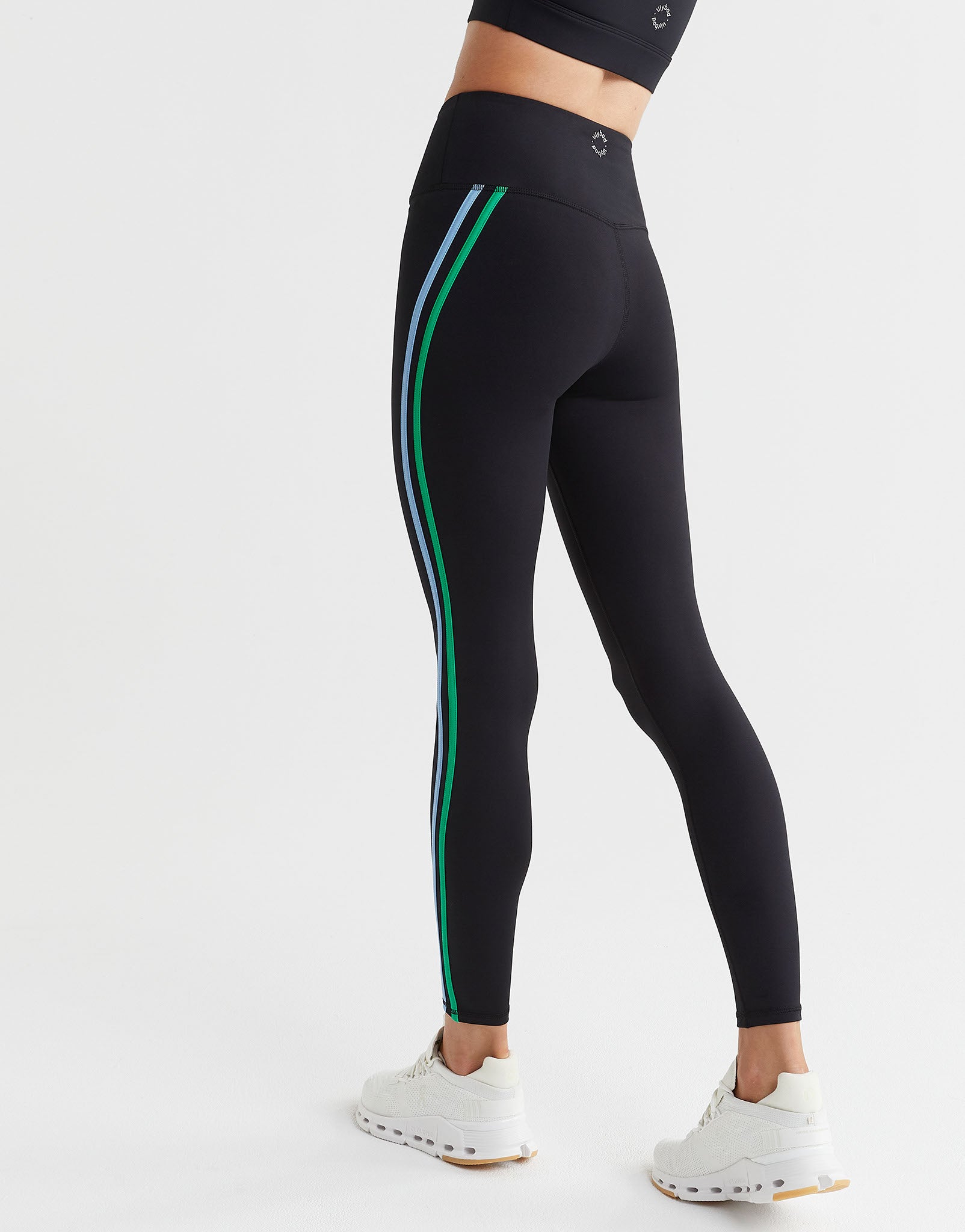 Black leggings with green and white stripes on a white background