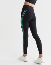 Black leggings with green and white stripes on a white background