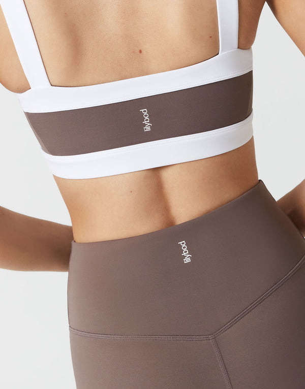 Close up of a brown and white sports bra and brown leggings