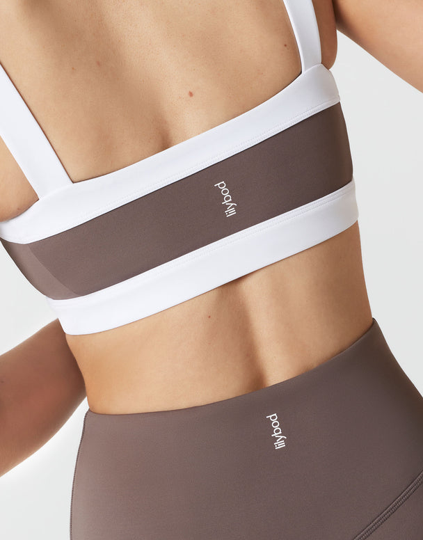 Athletic bra and leggings with 'Lilybod' branding on a neutral background