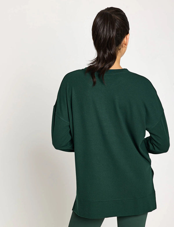 Woman wearing a green sweater on a white background