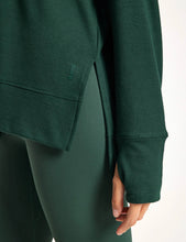 Green sweatshirt with a brand logo on a white background