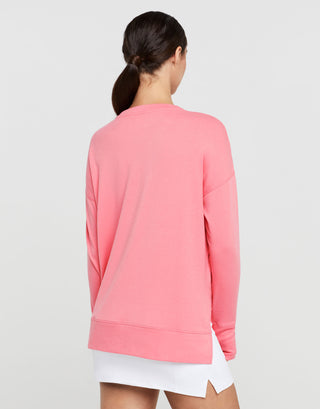 Person wearing a pink sweatshirt on a light gray background