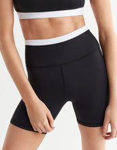 A pair of black and white active shorts and a top.