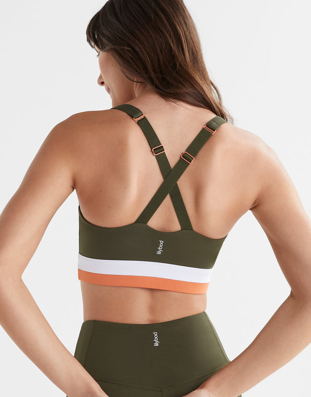 A woman wearing an olive green sports bra