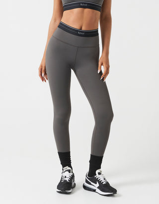 Person wearing gray leggings with a white background