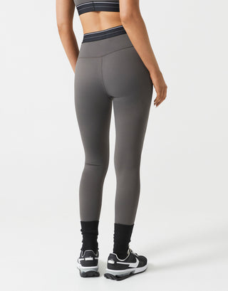 Person wearing gray leggings on a white background