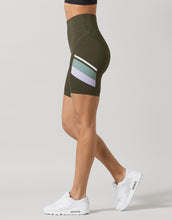 Woman wearing olive green activewear shorts