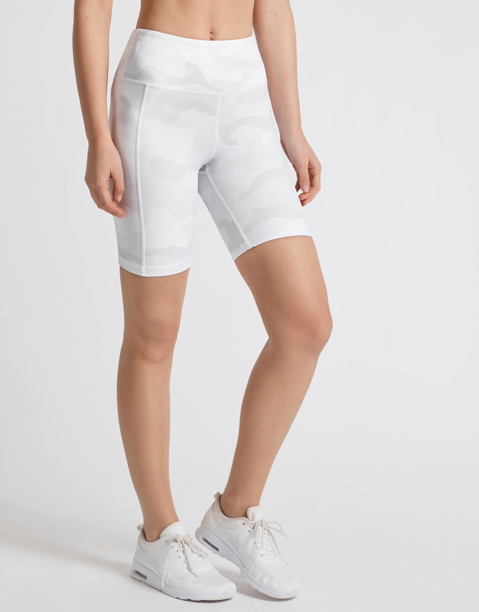 A pair of whispers tan camo bike shorts with back outer leg pockets, designed for high-waist fitting.