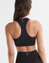 Black sports bra with brand logo on a plain background