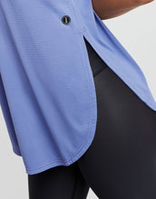 Blue athletic shirt with a brand logo on a gray background