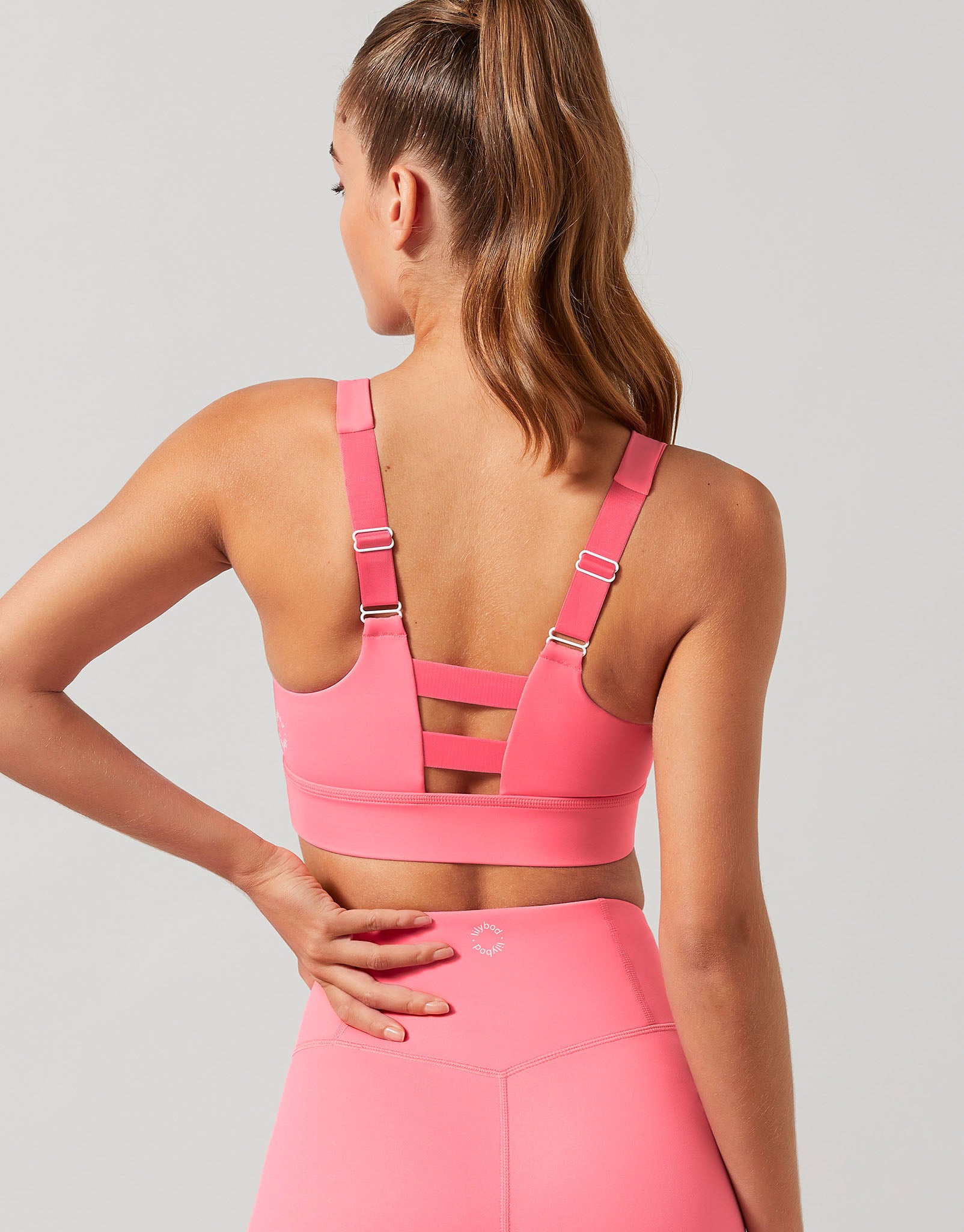 Woman wearing a pink sports bra by Holistic Femme
