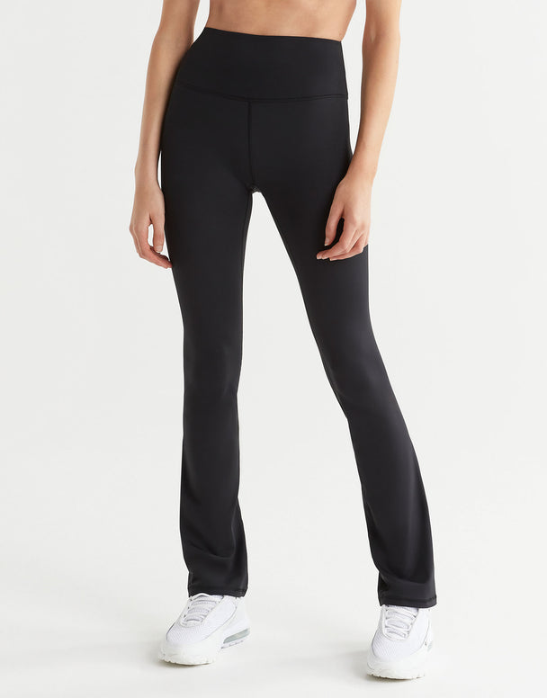 A pair of high-waisted black bootcut leggings, shown from the waist down with a focus on the fit and design of the leggings.