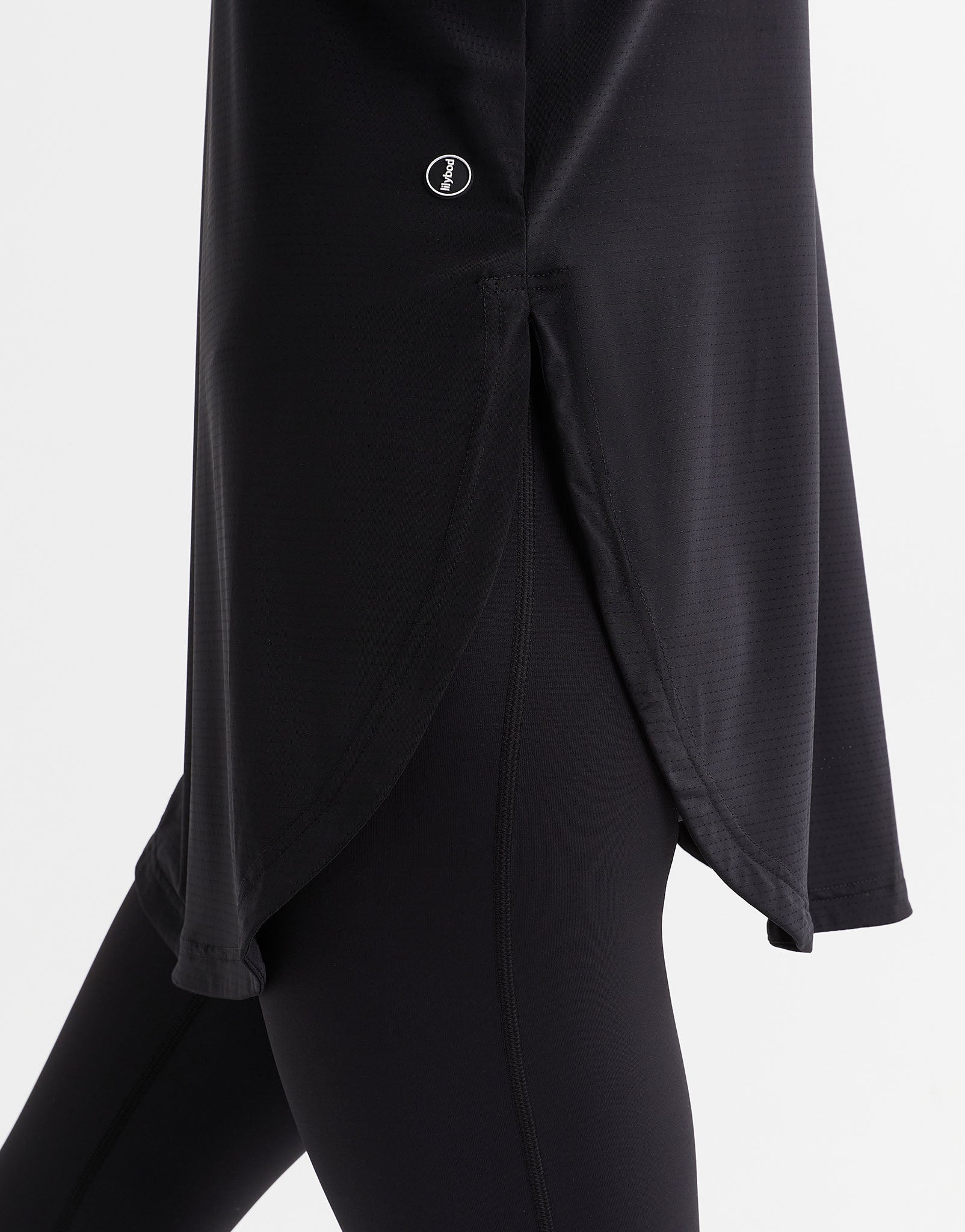 Black outfit with a button detail on a white background