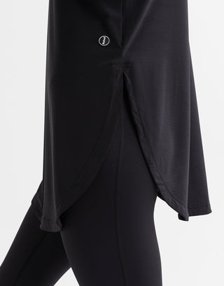 Black outfit with a button detail on a white background