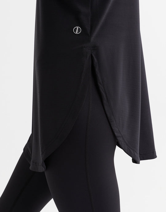 Black outfit with a button detail on a white background