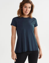 Woman wearing a dark blue t-shirt on a white background